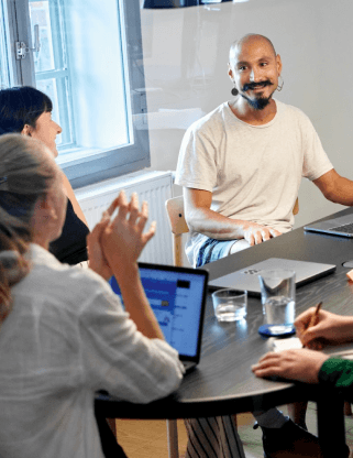 people sitting at a table and chatting about code